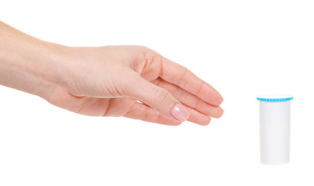 istock Hand with homeopathy bottle isolated on white background. 1291836507
