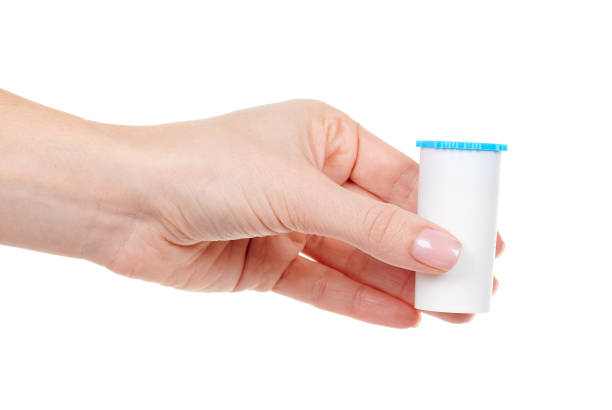 istock Hand with homeopathy bottle isolated on white background. 1291836510