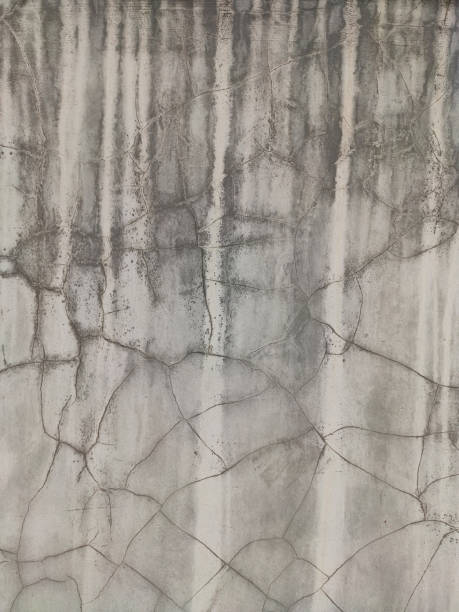 istock Grey Concrete Texture old wall with peeling paint, scratches and cracks 1291836671