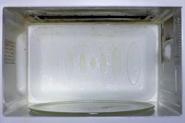 istock Dirty microwave. With burnt paint on the walls 1291837496