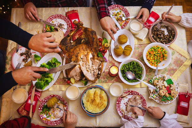 istock Young father carving stuffed roasted turkey for Christmas dinner 1291837532