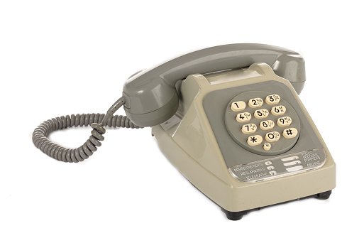 Vintage grey touchtone phone on white background