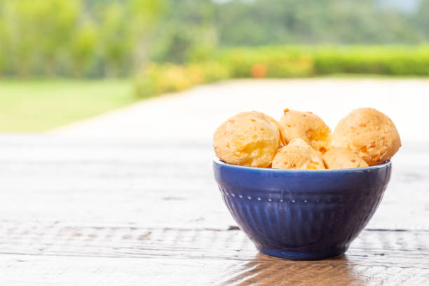 istock Brazilian Food, Cheese Bread. On rustic table, with space for text. 1291839665