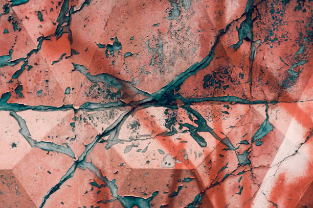 istock Cracked concrete wall covered with red paint 1291840623