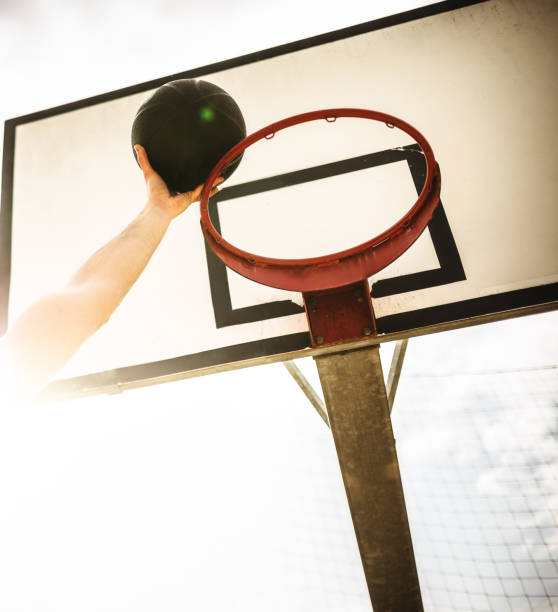 istock hand scoring a goal - basketball 1291841465
