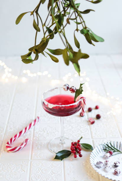 istock Festive Cranberry Cocktail for Christmas with mistletoe 1291842122