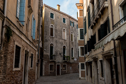 Venice, Italy - August 30, 2019: Old street view in Venice with old building in a sunny summer day.