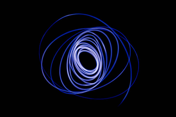 light streaks in the shape of circles. a trace of a moving light point. dark background. - blue streak lights imagens e fotografias de stock