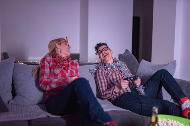 istock Two women playing video games at home 1291850854