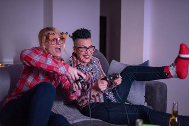 istock Two women playing video games at home 1291850924
