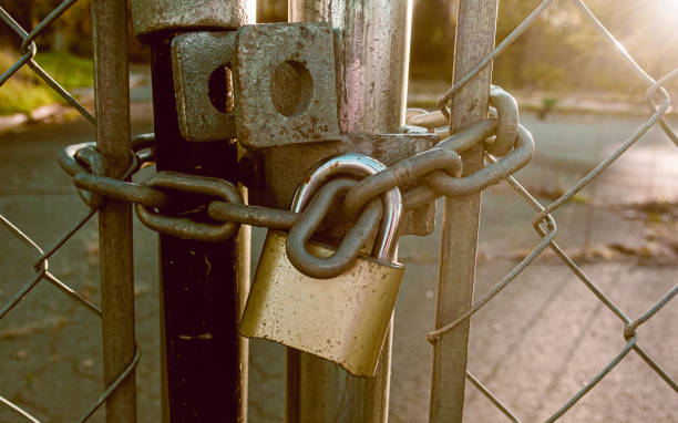 istock Locked Gate Tethered by metal chain and old rusty padlock. 1291852740