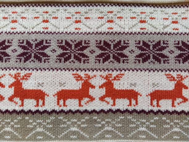 istock Real red knitted background with white Christmas deer and snowflakes 1291852761