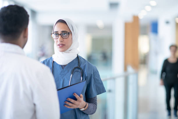 istock Middle eastern female nursing talking to doctor 1291853862