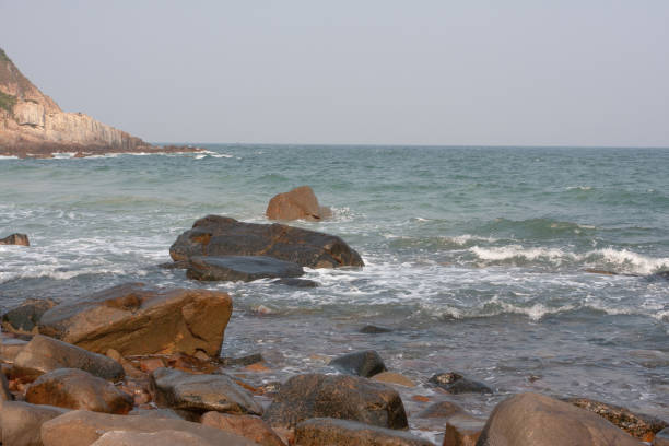istock 20 Oct 2007 sea wave crashing on rock coast with spray, hk 1291853874