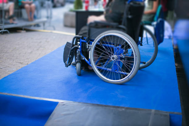 performer on handicap chair on podium next to access ramp