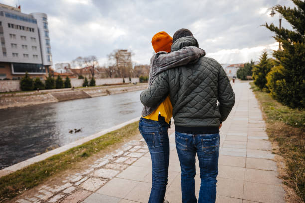 istock Young couple walking on city quay 1291857544