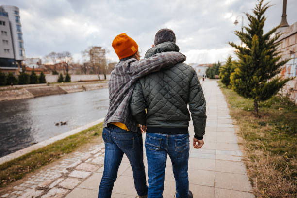 istock Young couple walking on city quay 1291857545