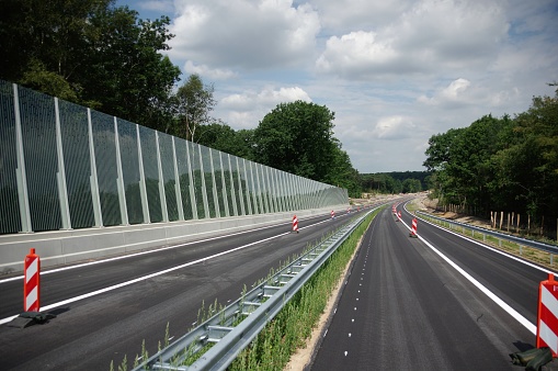 New installed glass noise barrier near the highway