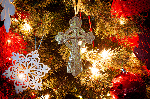 Close-up of cross ornament on a christmas tree