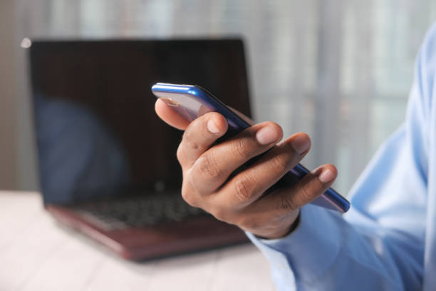 istock Close up of young man hand using smart phone. 1291863729