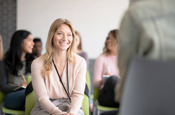 istock Female professor smiling at student 1291863733