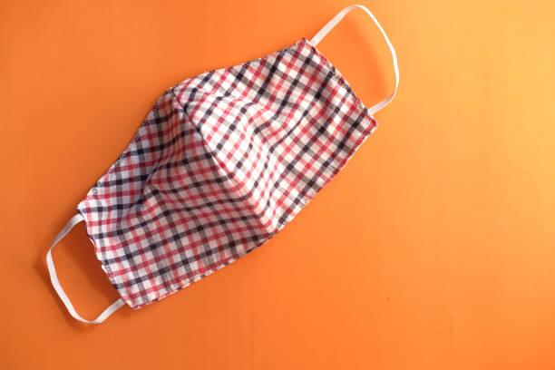 istock homemade face masks on orange background top down 1291864587
