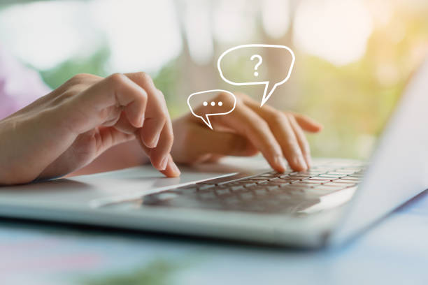istock People hand using laptop typing, chatting or text  messages in chat icons pop up. Social media maketing technology concept. Vintage soft color tone background. 1291872163