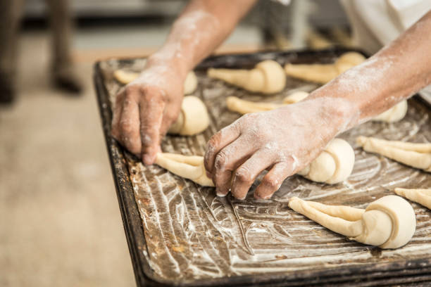 istock hands of the baker kneading the dough 1291875712