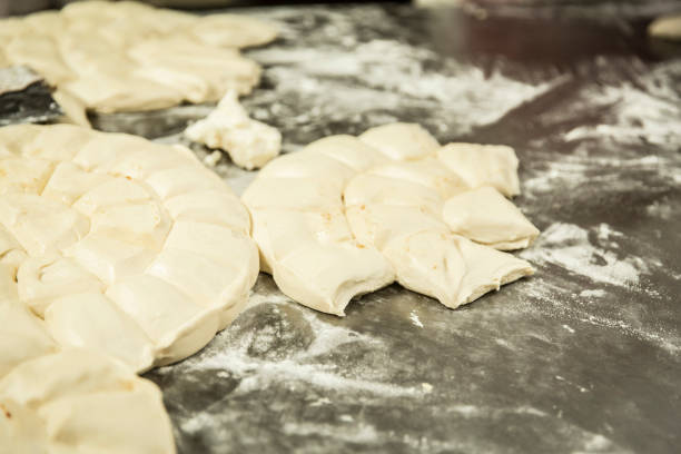 istock hands of the baker kneading the dough 1291875740