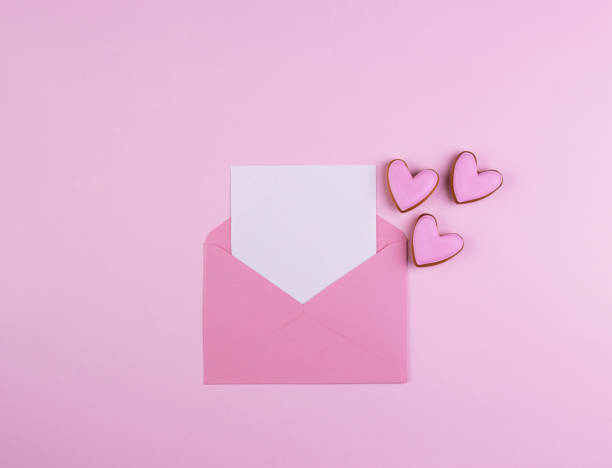 istock Envelope with a red heart for Valentine's Day on a pink background 1291879612