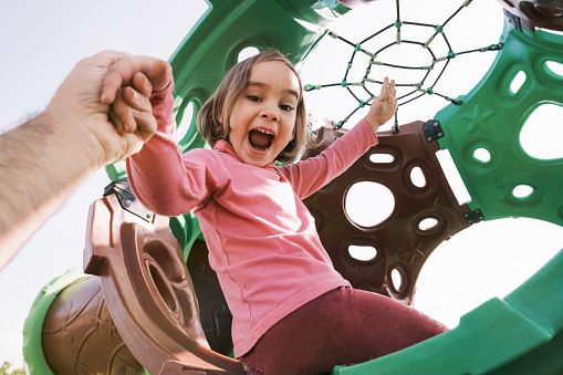 Portrait Of A Happy Child Girl Playing At Playground