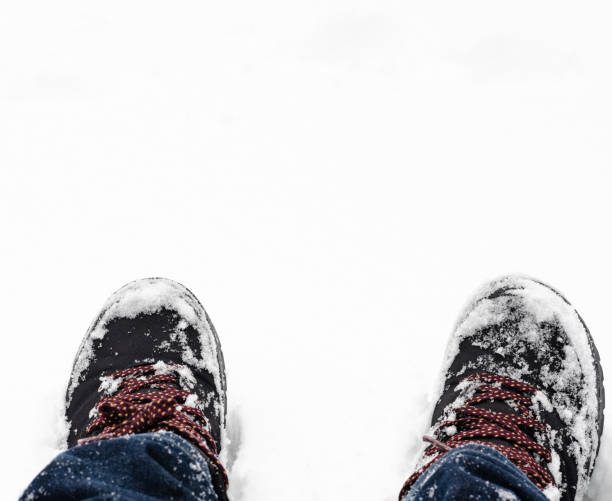 istock Close-up of  snow-covered boots  durring  winter 1291885001
