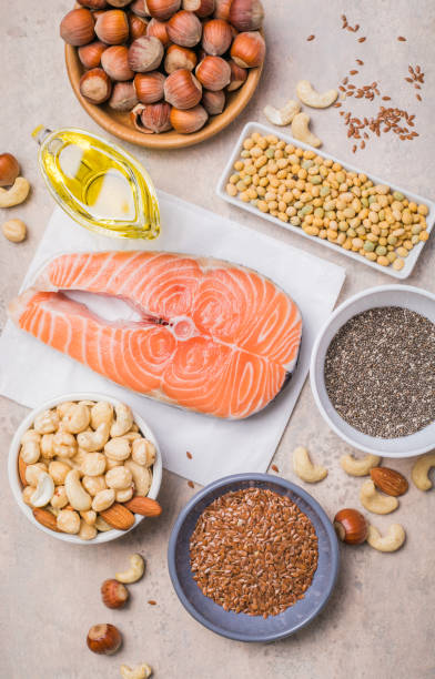 Omega 3 food sources and omega 6 on concrete background, top view copy space. Foods high in fatty acids including vegetables, seafood, nut and seeds stock photo