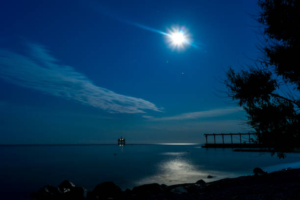 istock Moon over sea and stone coast 1291888784