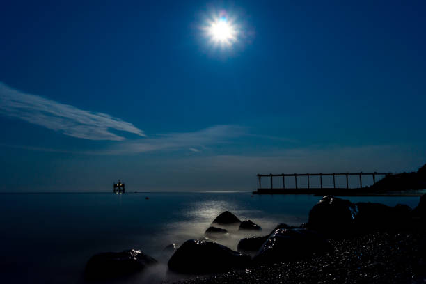 istock Moon over sea and stone coast 1291888785