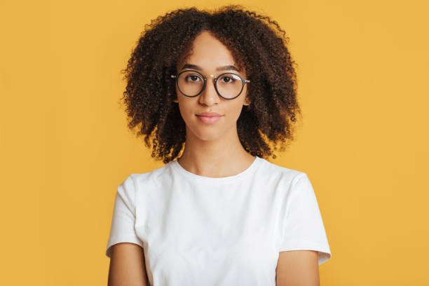 istock Nerd student ready to study. Smart serious african american lady in glasses looking at camera 1291889453