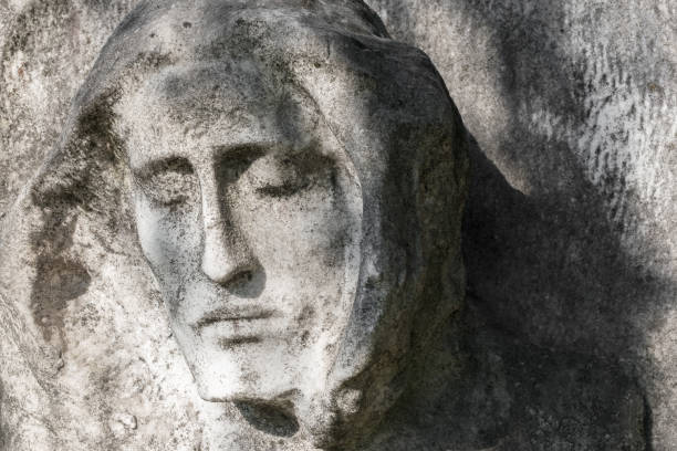 A head of a girl from a gravestone with stains looking like tears