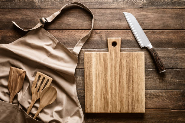 istock Culinary background, kitchen utensils and apron on kitchen countertop with blank space for any recipe or menu text 1291892603