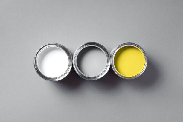 istock Open paint cans on grey background. Appartment renovation, repair, building, design concept. Demonstrating trendy Color of the Year 2021. Illuminating Yellow and Ultimate Gray. Duotone 1291892783