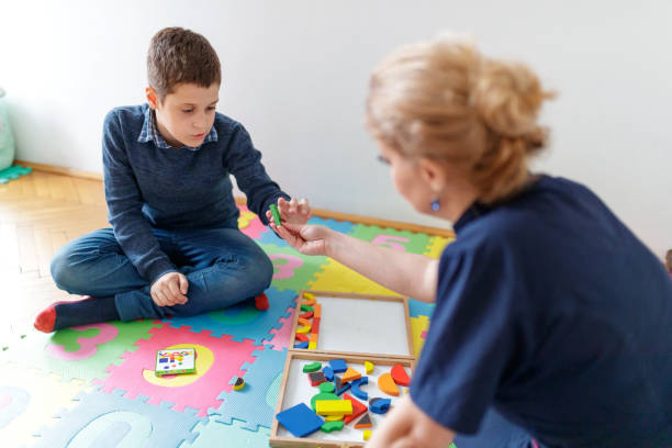 istock Boy taking shape from female tutor to arrange according to illustration 1291893661