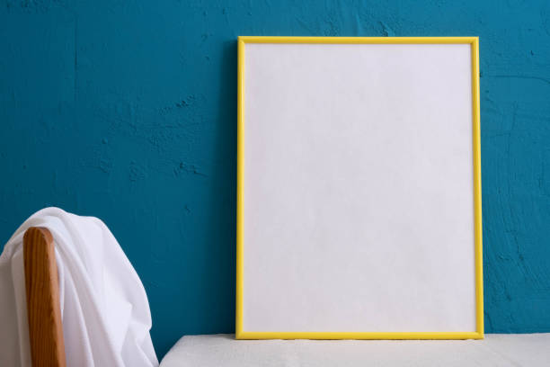 istock yellow large picture frame on a blue background on the table 1291894881
