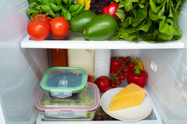istock Open fridge full of fruits, vegetables and drinks 1291895842