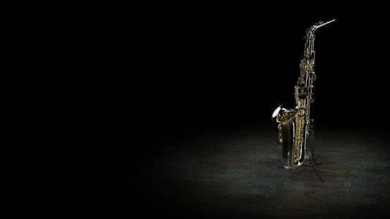 Alto sax resting on the floor of a stage.