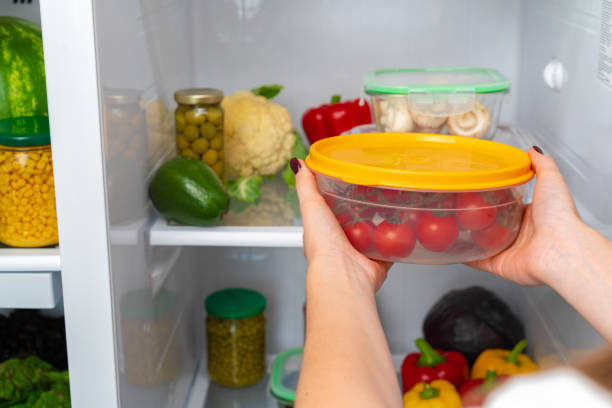 istock Female hands taking storage box with food from a fridge 1291898965