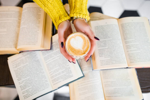 istock Morning coffee with a pattern on the background of books. 1291900322