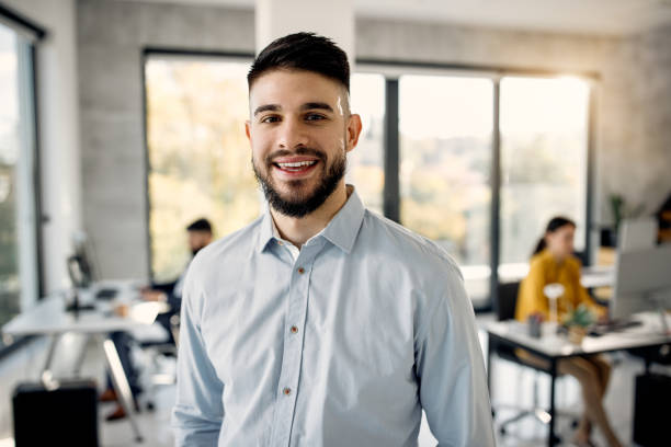 istock Happy male entrepreneur in the office looking at camera. 1291900336