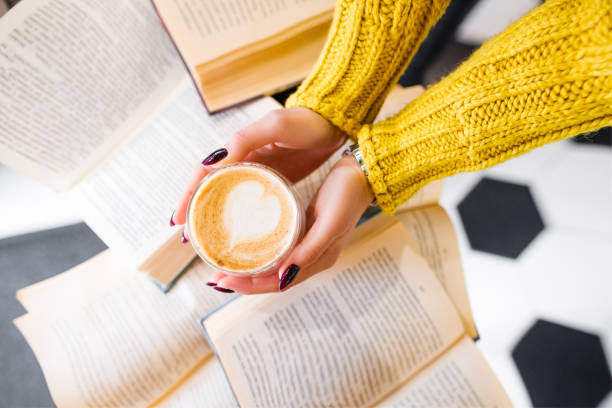 istock Morning coffee with a pattern on the background of books. 1291900352