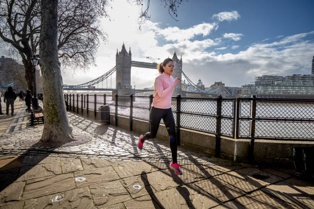 istock Young woman running down the pier by the River Thames 1291901514