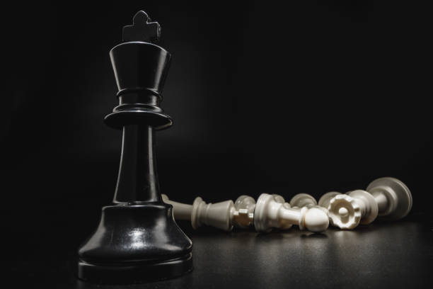 istock Chess game with chess pieces against black background 1291902641