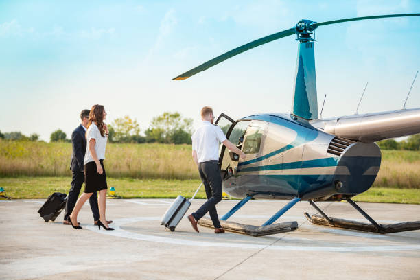 istock Helicopter pilot reaching for vehicle doorknob, passengers behind 1291902803